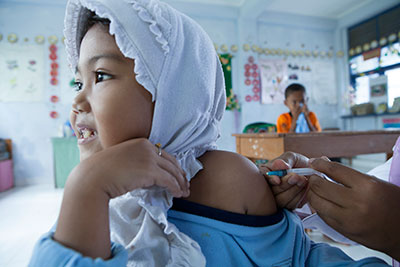 A child in Lhoksemawe, Aceh, Indonesia, receives a vaccine injection.